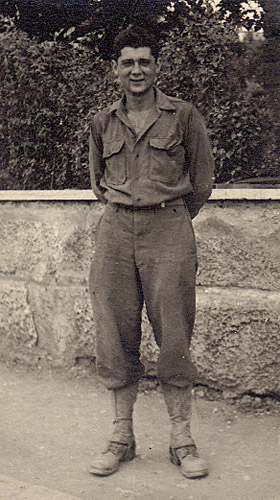 a black and white photo postcard of a soldier wearing fatigues in Italy 1944
